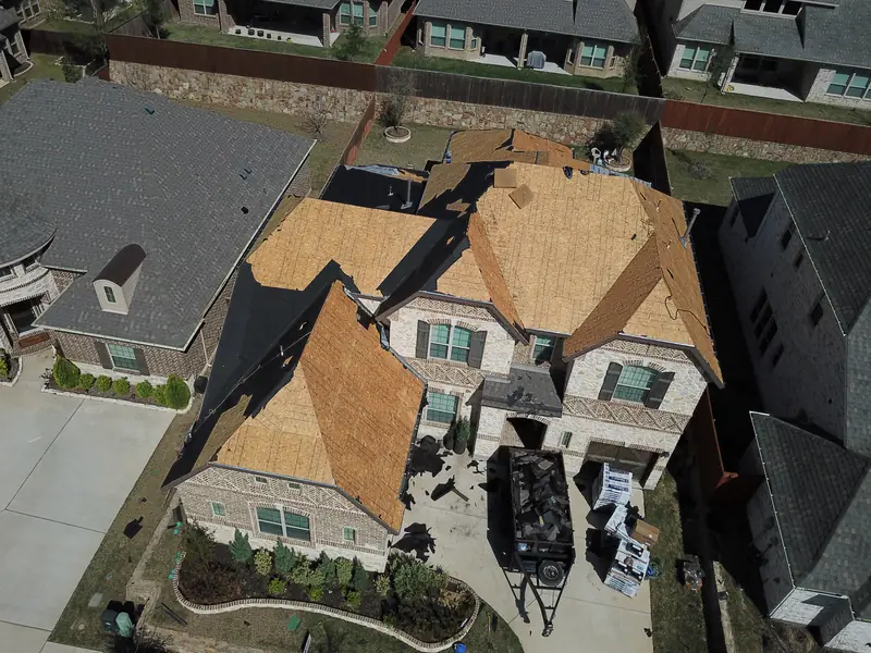 Aerial view of a McKinney roof replacement with new decking going down