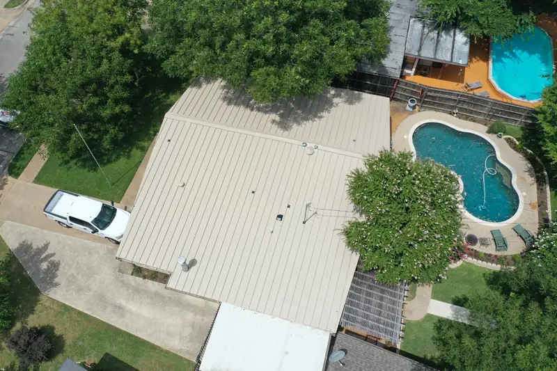 Standing seam metal roof on a home with a backyard pool