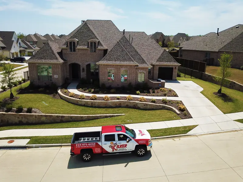 Kilker Roofing truck in front of a finished roof replacement in Prosper, Texas